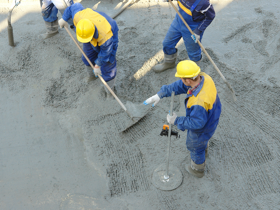 professional concrete workers working on concrete construction